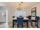 Modern dining room with table and chairs, striking chandelier, natural light, and contemporary art at 3543 Algonquin Dr, Las Vegas, NV 89169