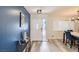 Bright foyer featuring stylish blue accent wall, modern light fixture, and an inviting white front door at 3543 Algonquin Dr, Las Vegas, NV 89169