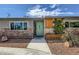 Inviting front entrance with brick accents, planter, and a bright green door under a cloudy sky at 3543 Algonquin Dr, Las Vegas, NV 89169