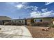 Charming single-story home with desert landscaping, unique brick accents and a curved driveway under a cloudy sky at 3543 Algonquin Dr, Las Vegas, NV 89169