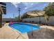 Beautiful backyard pool with lounge chairs and a large sun umbrella at 3543 Algonquin Dr, Las Vegas, NV 89169