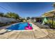 Inviting backyard pool with lounge seating and a lovely pergola-covered area at 3543 Algonquin Dr, Las Vegas, NV 89169