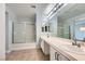 Spacious bathroom with double sinks, and a tub with sliding glass doors at 3558 Harbor Tides St, Las Vegas, NV 89147