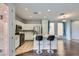 Modern kitchen featuring stainless steel appliances, white cabinetry, and a convenient breakfast bar at 3558 Harbor Tides St, Las Vegas, NV 89147