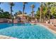 Sparkling community pool with inviting lounge area, palm trees and lush landscaping for relaxation at 3558 Harbor Tides St, Las Vegas, NV 89147