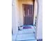 Close-up of condo entrance with secure screen door, welcome mat, and textured wall at 3845 Wiggins Bay St # 104, Las Vegas, NV 89129