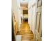 Hallway with wood-look flooring leading to the bedroom with ample storage at 3845 Wiggins Bay St # 104, Las Vegas, NV 89129