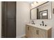 Bathroom vanity with double sinks, wood-look cabinets and contemporary fixtures at 3853 Kellogg Ave, Las Vegas, NV 89115