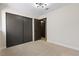 Bedroom features neutral carpet, closet with sliding doors, and access to an adjacent room at 3853 Kellogg Ave, Las Vegas, NV 89115