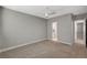 Neutral bedroom with ceiling fan, gray walls, carpet, and ensuite bathroom at 395 W Cox Ave, Overton, NV 89040