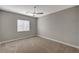 Bright carpeted bedroom showcasing a window with blinds and ceiling fan at 395 W Cox Ave, Overton, NV 89040