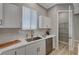 Close up of a kitchen with stainless appliances, pantry and white cabinets at 395 W Cox Ave, Overton, NV 89040