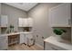 Functional laundry room with white cabinets and shelving for storage at 395 W Cox Ave, Overton, NV 89040