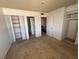 Bedroom featuring carpeting, closet space, and views into the attached bathroom and the top of the staircase at 4770 Topaz St # 31, Las Vegas, NV 89121