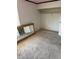 Standard bedroom with tan carpet, empty closet, and large mirror leaning against wall at 4770 Topaz St # 31, Las Vegas, NV 89121