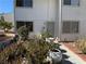 Townhouse exterior featuring a well-maintained garden area with aloe plants and potted vegetation at 4770 Topaz St # 31, Las Vegas, NV 89121