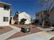 Townhouse exteriors with well-maintained desert landscaping and concrete walkways at 4770 Topaz St # 31, Las Vegas, NV 89121