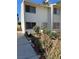 Townhouse exterior showing a front entrance surrounded by desert landscaping and potted plants at 4770 Topaz St # 31, Las Vegas, NV 89121