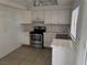 Kitchen featuring white cabinets, stainless steel appliances, and tile flooring at 4770 Topaz St # 31, Las Vegas, NV 89121