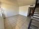 Cozy living room with tile flooring and access to the staircase at 4770 Topaz St # 31, Las Vegas, NV 89121