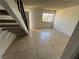 Open living area with tile flooring, staircase, and natural light at 4770 Topaz St # 31, Las Vegas, NV 89121