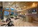 Home gym featuring mountain views, exercise equipment, bar, and wood ceiling at 4888 Snow White Rd, Las Vegas, NV 89124