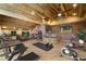 Spacious gym with modern exercise equipment, wooden ceiling, exposed brick, and sports memorabilia at 4888 Snow White Rd, Las Vegas, NV 89124