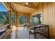 Sunlit hallway with wood paneled ceiling and walls, wrought iron staircase, and mountain view at 4888 Snow White Rd, Las Vegas, NV 89124