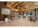 Cozy living room features brick wall, wood ceiling, bar seating, and comfortable furniture at 4888 Snow White Rd, Las Vegas, NV 89124