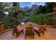 Outdoor patio area featuring a built-in grill, stone fire pit, and Adirondack seating at 4888 Snow White Rd, Las Vegas, NV 89124