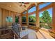 Bright sitting area with wood paneling, ceiling fan, and large picture windows showcasing the wooded scenery at 4888 Snow White Rd, Las Vegas, NV 89124