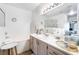 Bright bathroom features a tub, shower, vanity with ample counter space and decorative accessories at 502 Fragrant Orchard St, Henderson, NV 89015