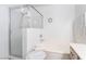 Bright bathroom featuring a glass shower, soaking tub with white tile, and modern fixtures at 502 Fragrant Orchard St, Henderson, NV 89015