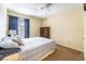 Bedroom with neutral colored walls, ceiling fan, carpeted floor and a large window for natural light at 502 Fragrant Orchard St, Henderson, NV 89015