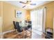 Cozy dining room with glass table, fan and sliding glass doors to the patio at 502 Fragrant Orchard St, Henderson, NV 89015