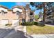 Two-story townhouse featuring a garage, inviting curb appeal, and manicured lawn at 502 Fragrant Orchard St, Henderson, NV 89015