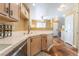 Bright kitchen with stainless steel dishwasher, warm cabinets, and modern sink at 502 Fragrant Orchard St, Henderson, NV 89015