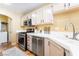 Cozy kitchen with stainless steel appliances, warm cabinets, and breakfast bar at 502 Fragrant Orchard St, Henderson, NV 89015