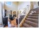 Living room with a fireplace, entertainment center, and staircase leading to the upper level at 502 Fragrant Orchard St, Henderson, NV 89015