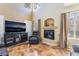 A cozy living room features a fireplace, entertainment center, and natural light from large windows at 502 Fragrant Orchard St, Henderson, NV 89015