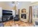 A cozy living room features a fireplace, entertainment center, and natural light from large windows at 502 Fragrant Orchard St, Henderson, NV 89015