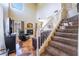 Living room with a fireplace, entertainment center, and staircase leading to the upper level at 502 Fragrant Orchard St, Henderson, NV 89015