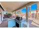 View of the outdoor kitchen featuring a built-in grill and counter space, backyard in view at 52 Vallejo Verde St, Henderson, NV 89012