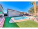 Lush backyard with a pool, artificial grass, and patio, great for outdoor enjoyment at 52 Vallejo Verde St, Henderson, NV 89012