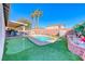 Backyard with a pool, turf, and a covered patio, perfect for outdoor entertaining at 52 Vallejo Verde St, Henderson, NV 89012