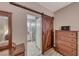 Bathroom with a sliding barn door, wood-look floors, and a view of the double sink vanity and glass shower at 52 Vallejo Verde St, Henderson, NV 89012