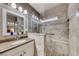 Well-lit bathroom with a glass shower featuring a built-in seat at 52 Vallejo Verde St, Henderson, NV 89012