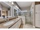 Modern bathroom featuring double sinks, granite countertops and glass shower at 52 Vallejo Verde St, Henderson, NV 89012