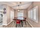 Dining room area with modern chandelier, shuttered windows and room for four at 52 Vallejo Verde St, Henderson, NV 89012