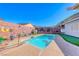 Refreshing pool and patio area surrounded by landscaping and decorative features at 52 Vallejo Verde St, Henderson, NV 89012